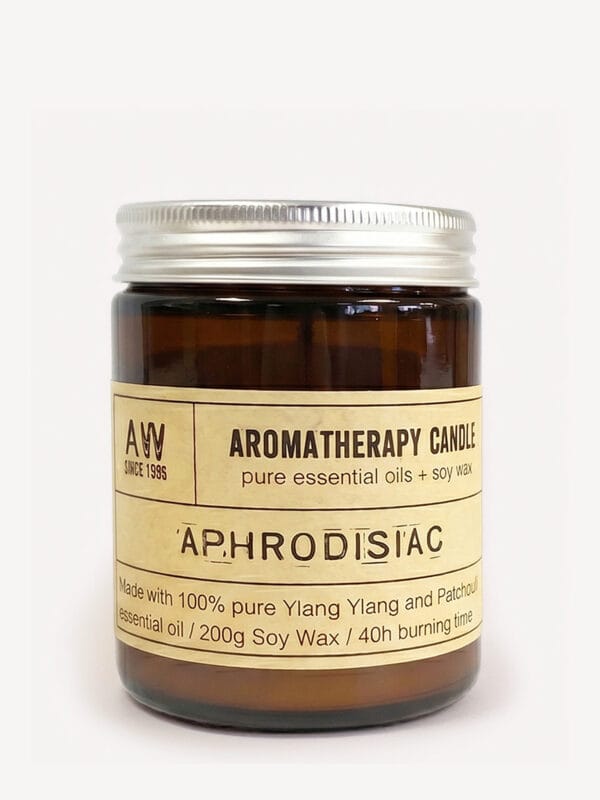Amber jar Aphrodisiac Ylang Ylang soy candle with silver lid and cream label.