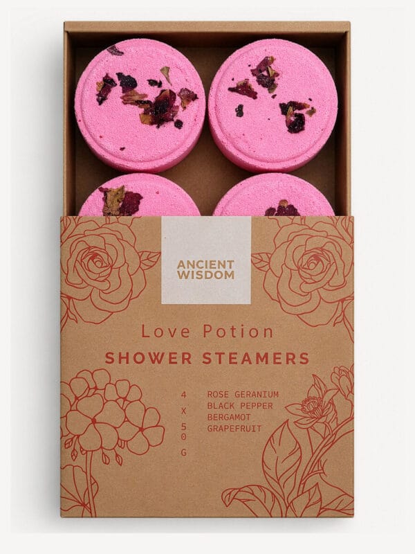 Box of four pink Love Potion shower steamers with dried petals and floral-printed sleeve.