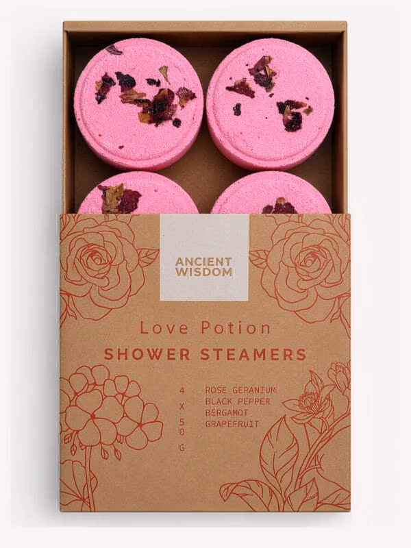 Box of four pink Love Potion shower steamers with dried petals and floral-printed sleeve.