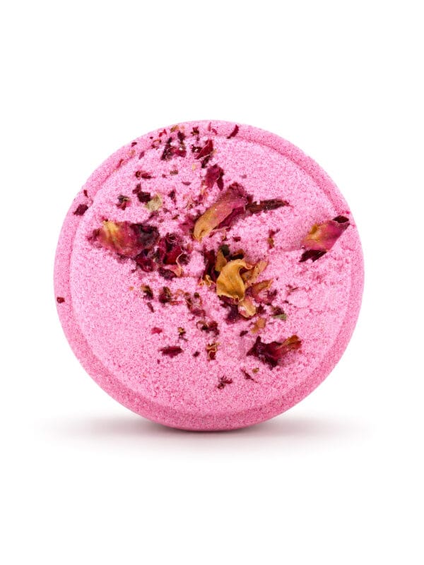 Round pink Love Potion shower steamer topped with dried rose petals on white background.