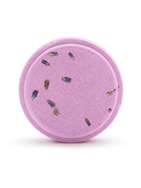Round lavender Relaxing shower steamer with dried lavender buds on white background.