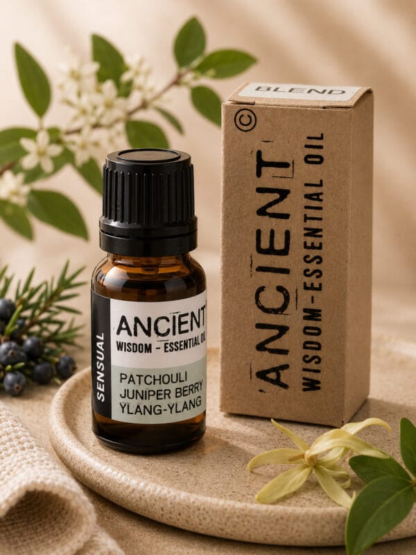 Sensual Patchouli & Ylang Ylang essential oil bottle with kraft box, juniper berries and ylang ylang flower.