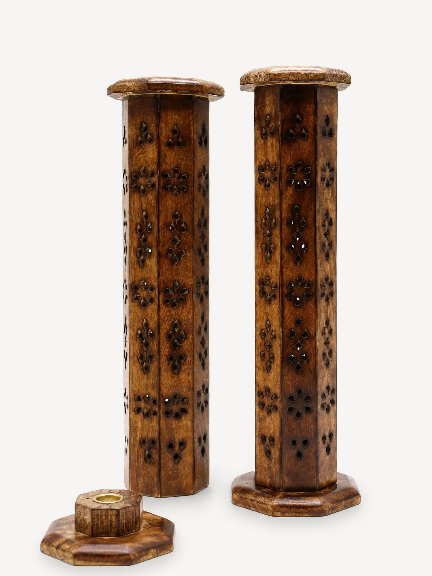 Hexagonal mango wood incense towers with floral cut‑outs and removable base showing brass holder.