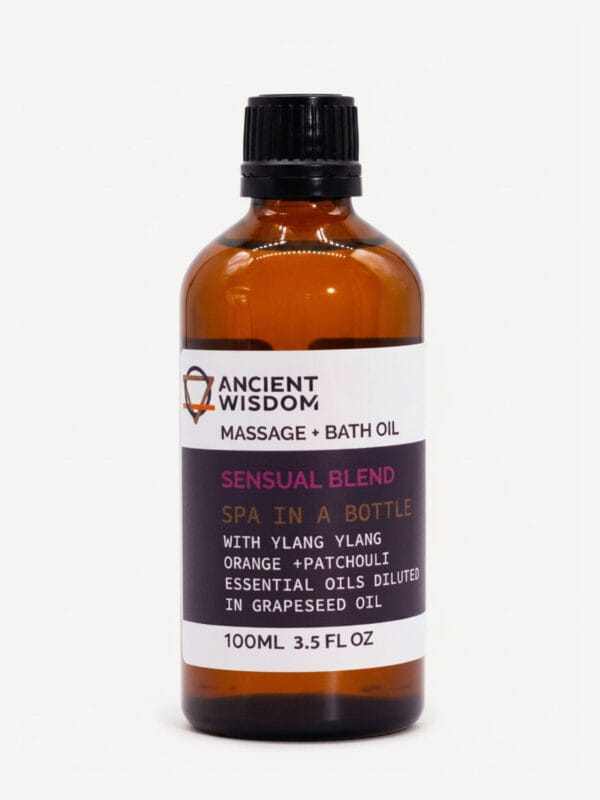 Ylang Ylang Sensual Massage Oil in amber bottle with black cap and purple label detailing essential oils.