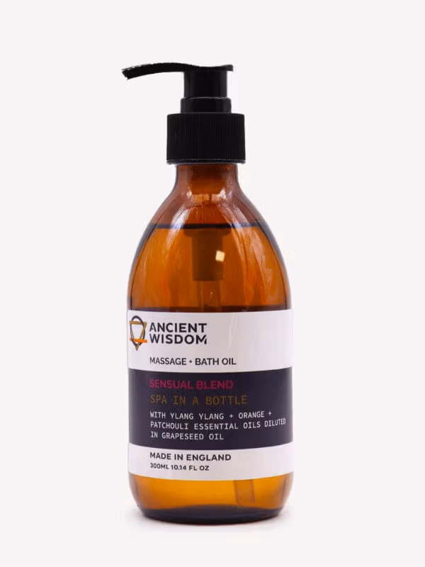 Ylang Ylang Sensual Massage & Bath Oil in large amber pump bottle with black dispenser and purple label.