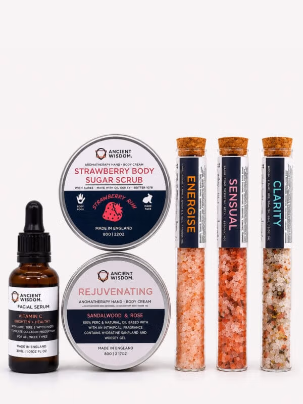 Celestial Serenity self-care kit items: two tins, a vitamin C facial serum and three test tubes of coloured bath salts.