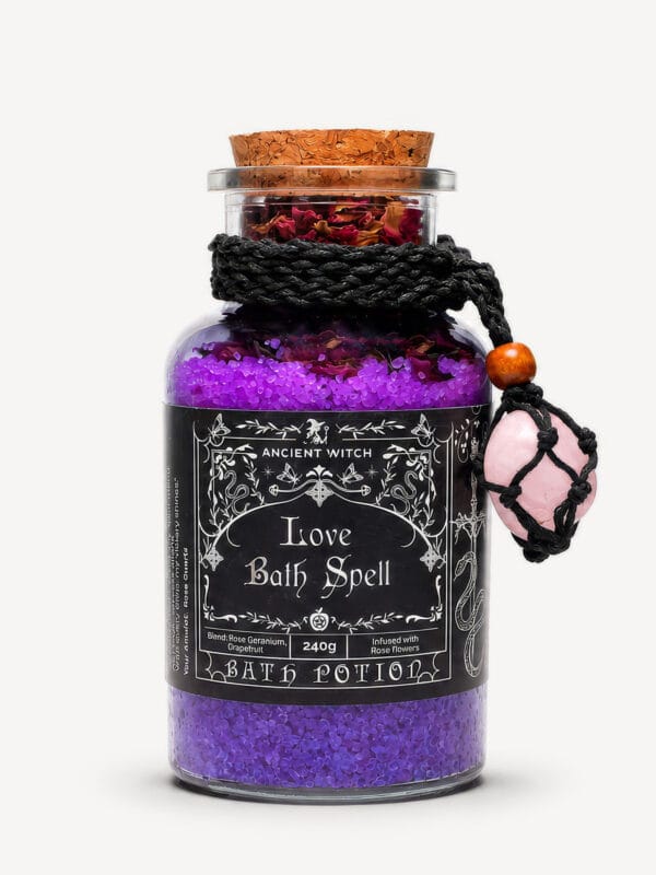 Love Bath Ritual jar filled with purple bath salts and dried roses, with rose quartz amulet tied around the neck.
