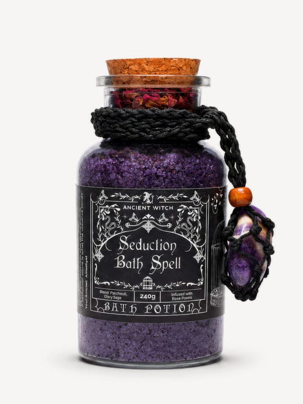 Seduction Bath Ritual jar of dark purple salts with amethyst crystal amulet hanging from braided rope.