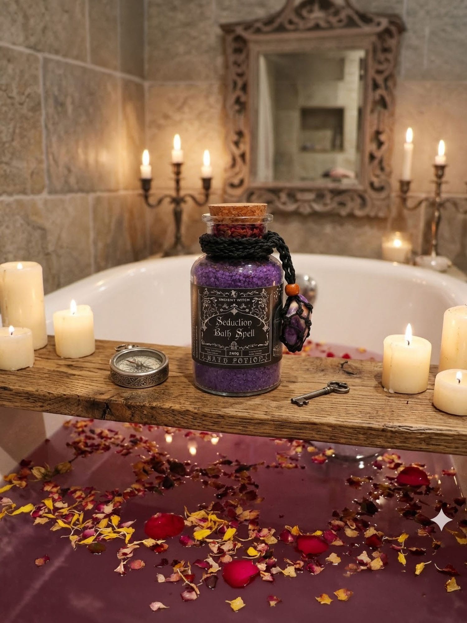 Seduction Bath Ritual jar on bath board with candles, key and compass over purple water with petals.