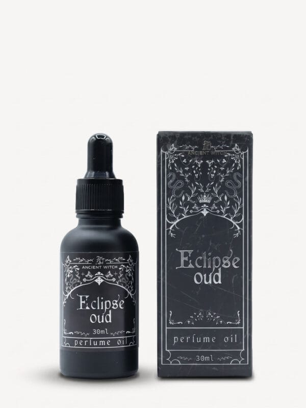 Eclipse oud perfume oil bottle with dropper and matching ornate black box.