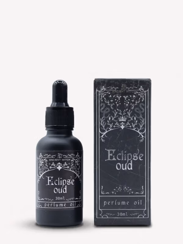 Eclipse oud perfume oil bottle with dropper and matching ornate black box.