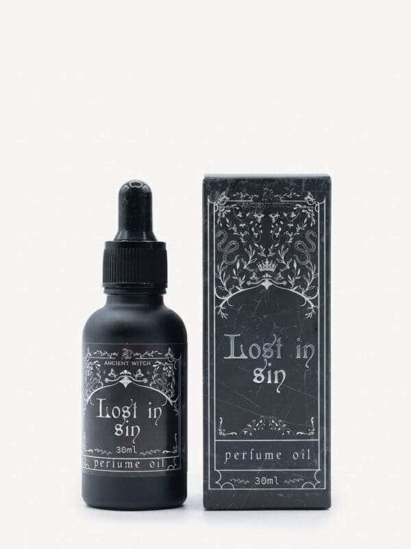 Lost in Sin perfume oil bottle with dropper next to matching ornate black box.