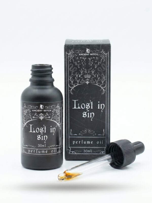 Open Lost in Sin perfume oil bottle with dropper pipette and ornate box behind.