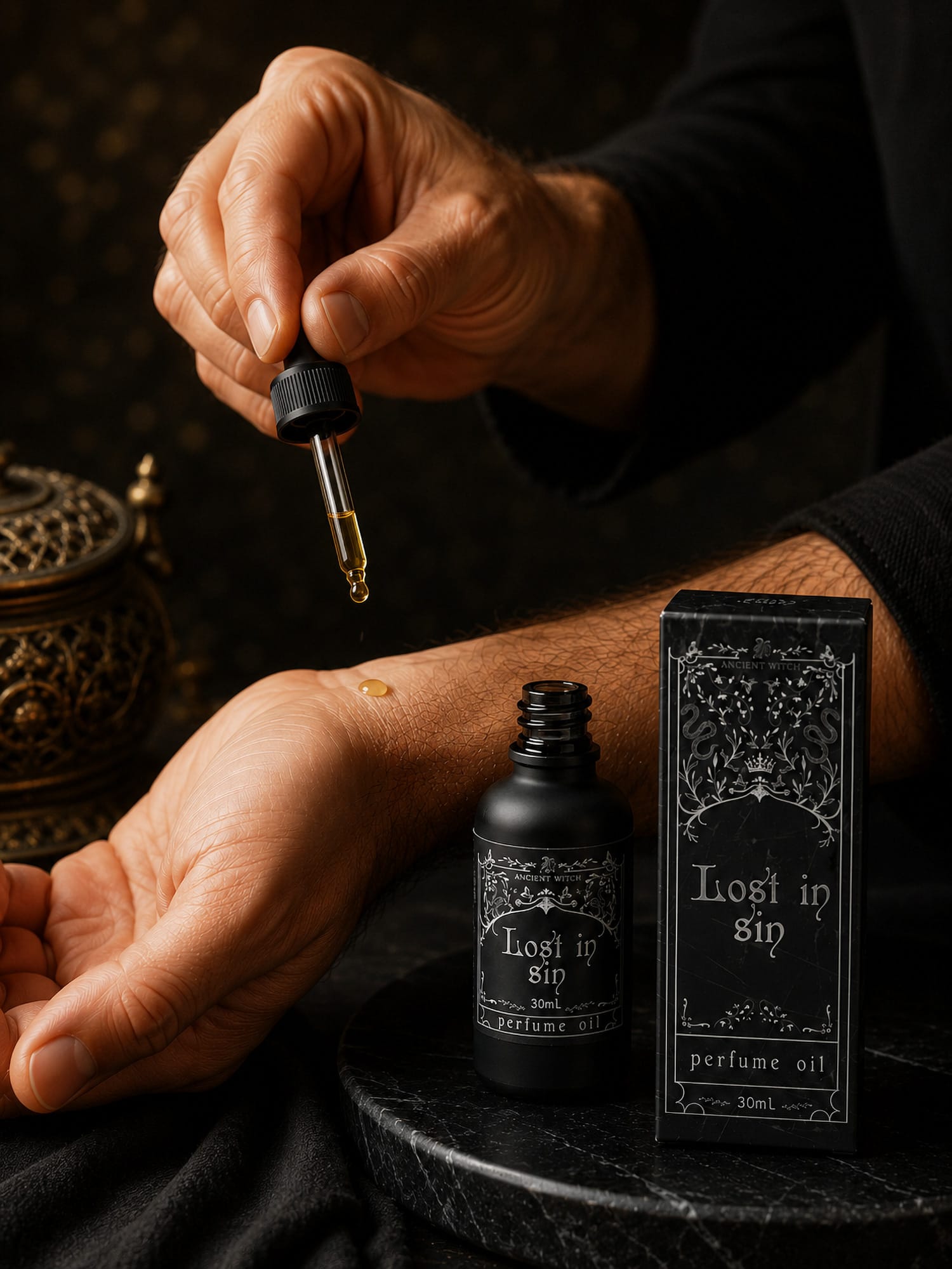 Hand applies Lost in Sin perfume oil onto wrist with open bottle and box on dark surface.