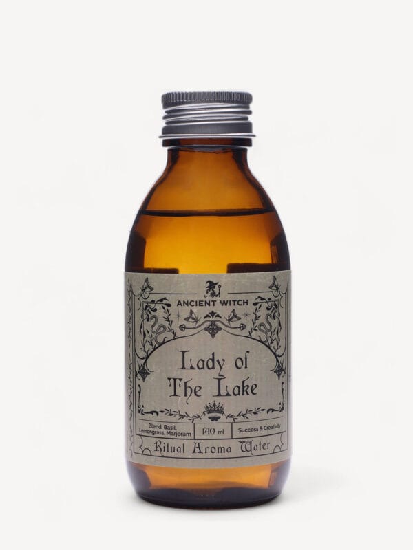 Lady of the Lake ritual water amber bottle with silver cap and ornate label.