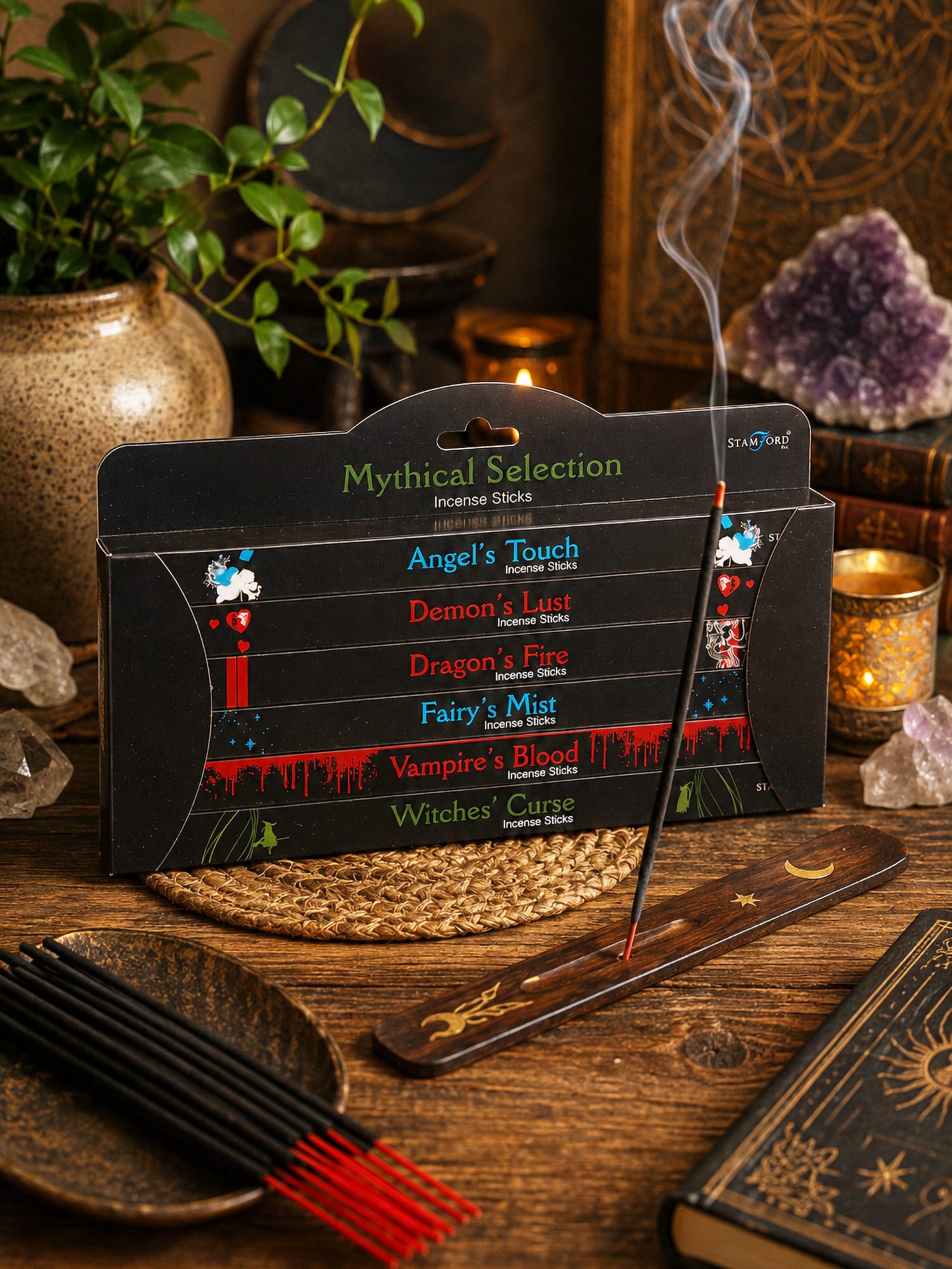 Mythical Selection incense box with burning stick on wooden holder, red-tipped sticks, amethyst and plants.