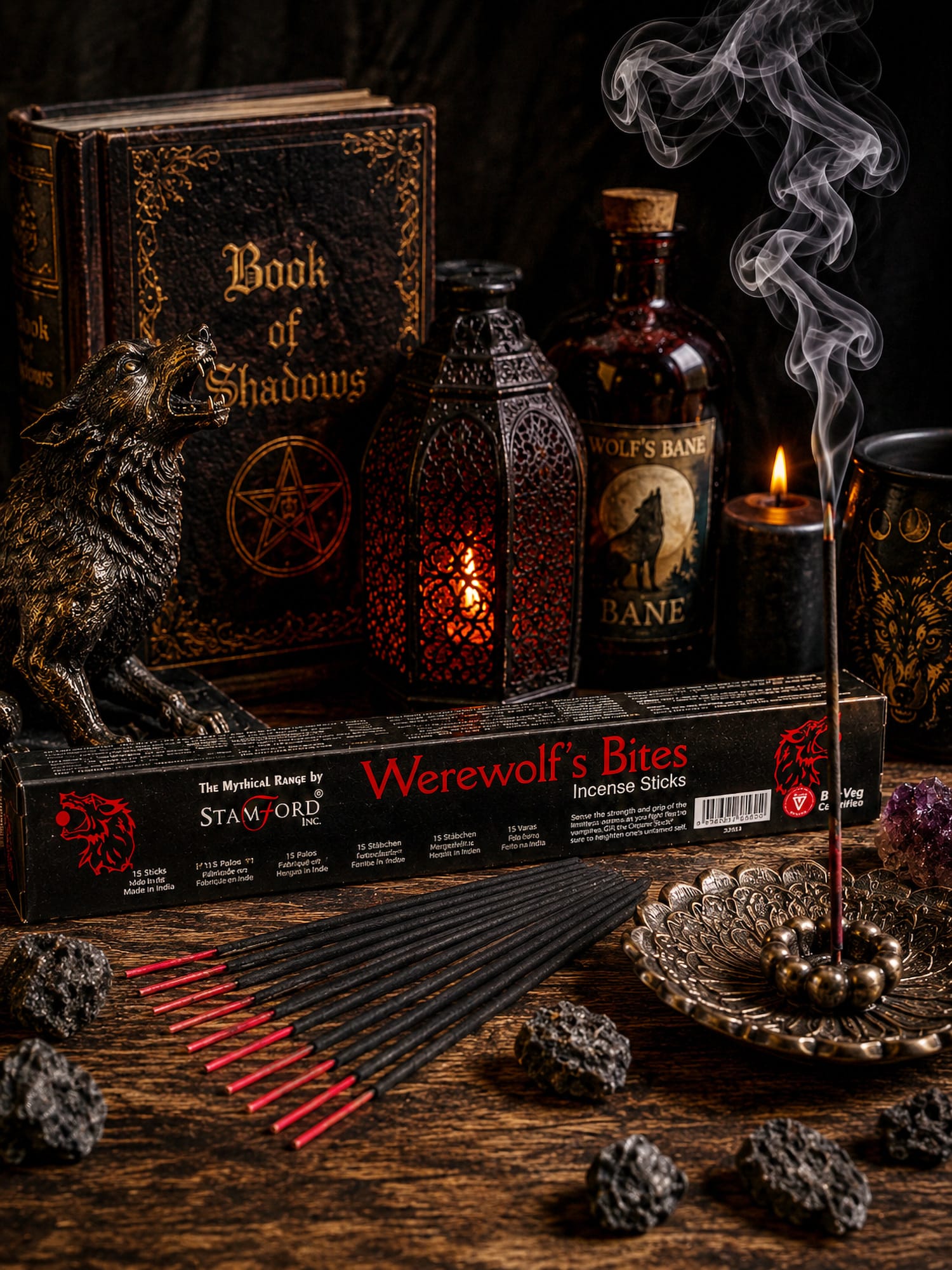 Werewolf's Bite incense with bronze holder, wolf statue, Book of Shadows and Wolf's Bane bottle under swirling smoke.