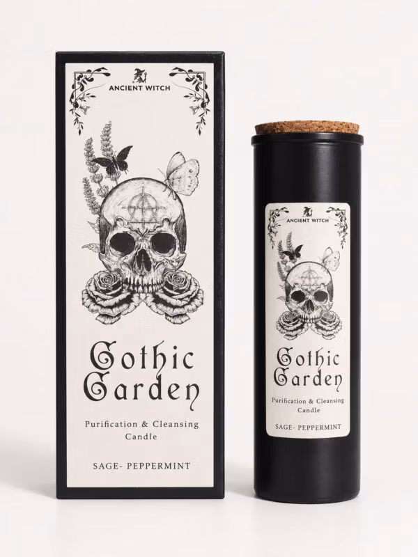 Ancient Witch Gothic Garden sage and peppermint ritual candle in a black glass jar beside its skull-and-rose gift box.