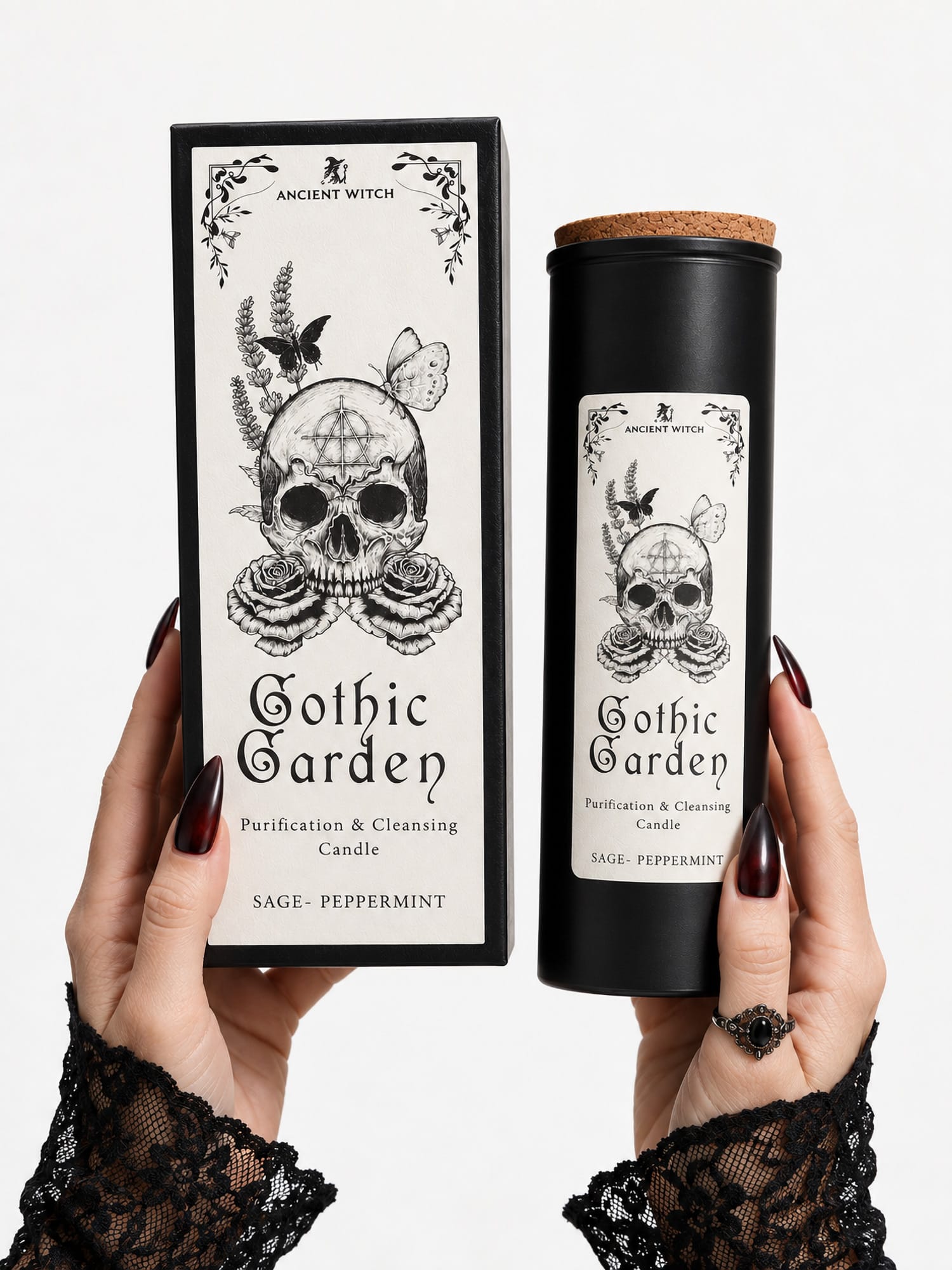 Hands with dark nails holding the Gothic Garden ritual candle and tall gift box to show their size.
