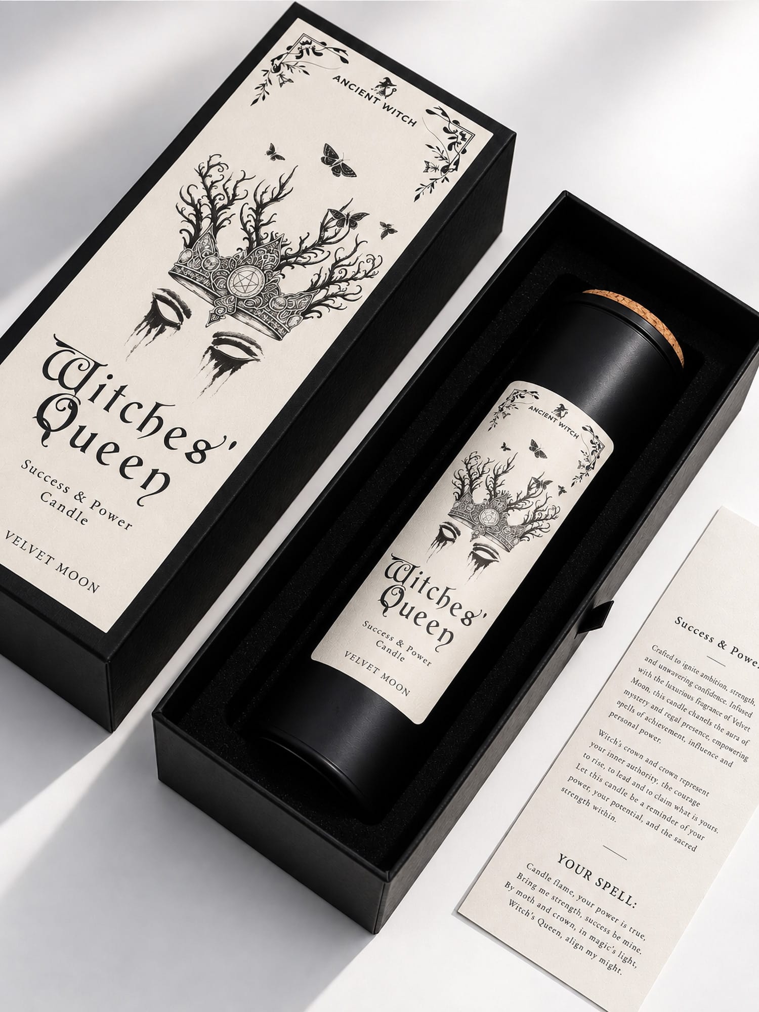 Witches’ Queen ritual candle presented inside an open black gift box with the illustrated lid and ritual spell card.