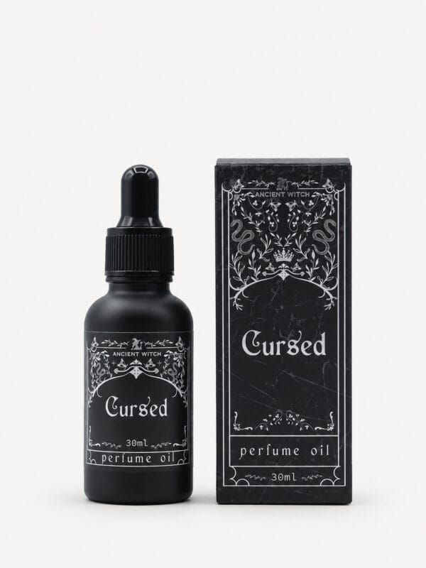 Ancient Witch Cursed perfume oil in a black 30ml dropper bottle beside its ornate black gift box.